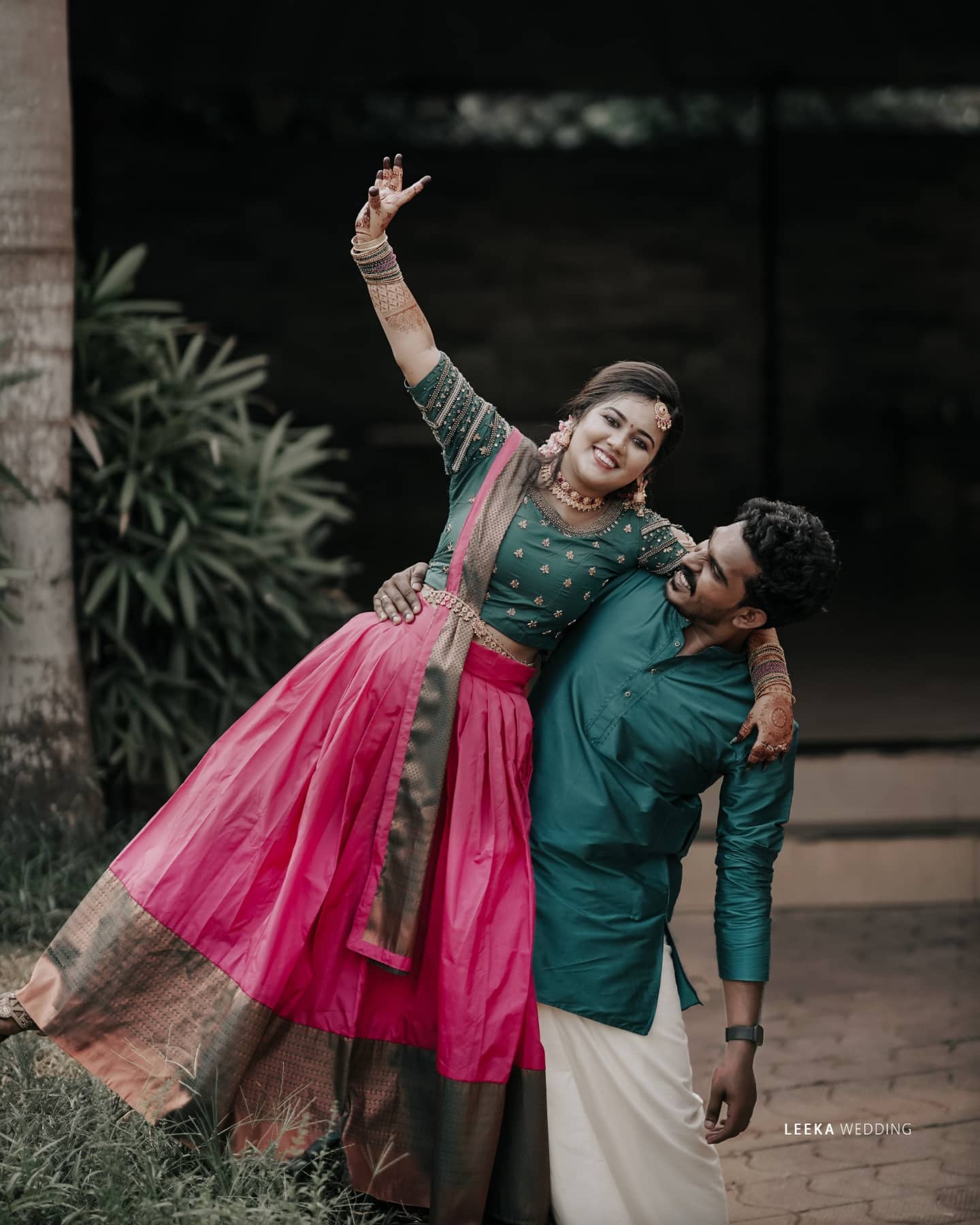 A wedding photographer in Bangalore taking a photo of a bride and groom