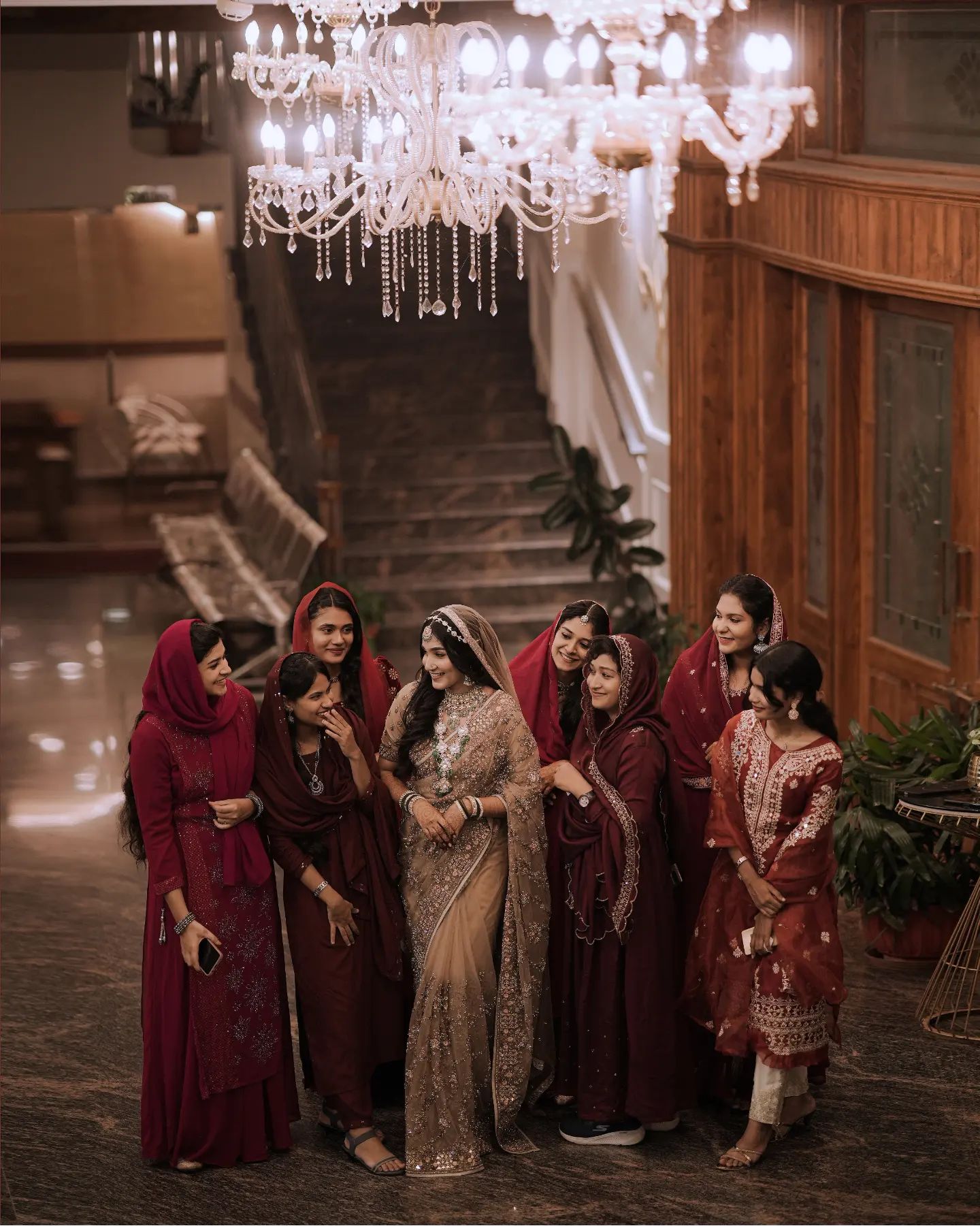 A wedding photographer in Bangalore taking a candid photo of a bride laughing with her bridesmaids