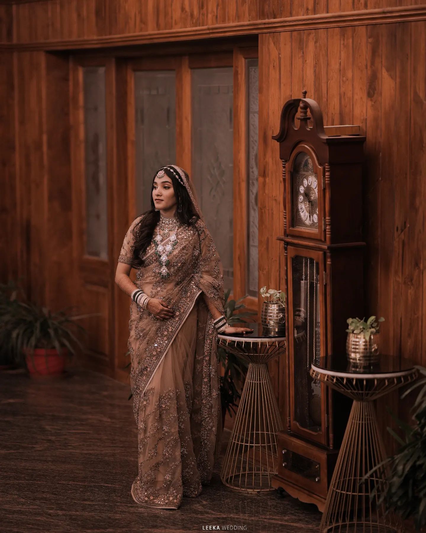 A wedding photographer in Bangalore taking a portrait of a beautiful bride wearing a Silver Rose lehenga and jewelry